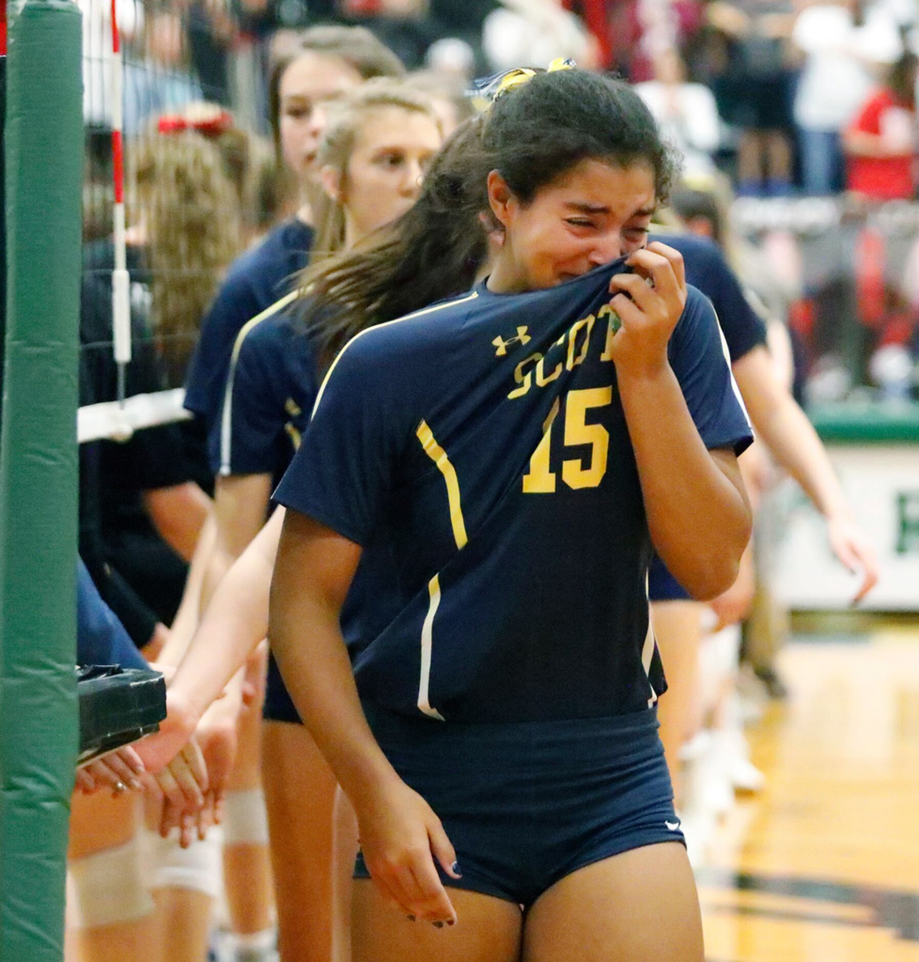 Highland Park High School defensive specialist Bela Alomar (15) wipes tears as Highland...