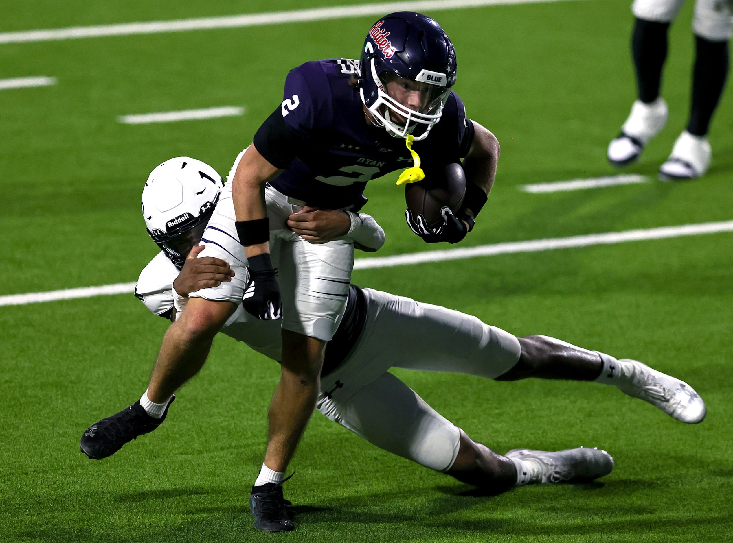 Denton Ryan quarterback Braeden Mussett (2) can't break a tackle from Mansfield Timberview...