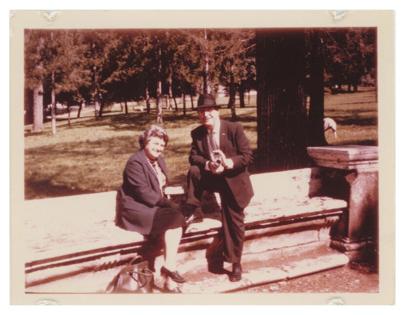 Abraham Zapruder, next to his wife, Lillian Zapruder, poses for a photograph holding his...