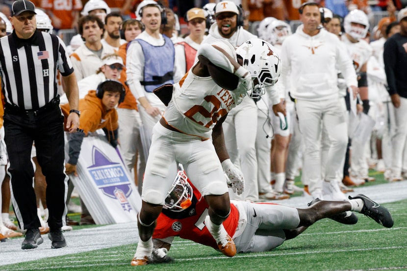 Texas running back Quintrevion Wisner (26) is tackled by Georgia defensive back Daniel...