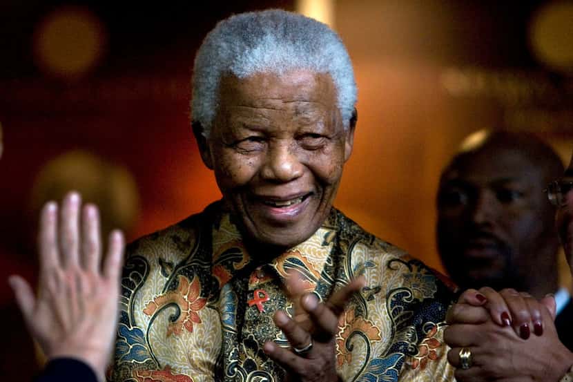 In this Oct. 6, 2007, file photo, former South African President Nelson Mandela reacts after...