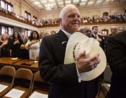  Commissioner of Agriculture Sid Miller holds his cowboy hat over his heart in January...