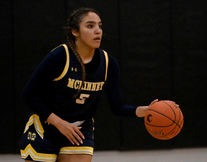McKinney’s Trinity White (5) brings the ball up court in the second half of a girls high...