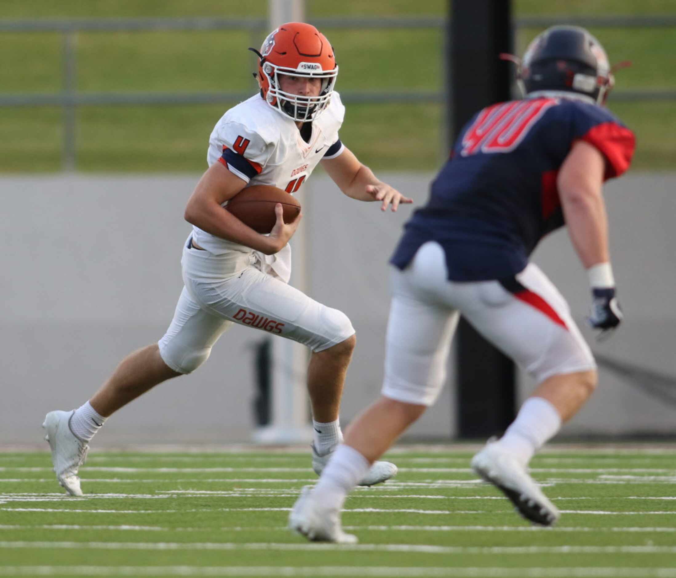 McKinney North quarterback Dillon Markiewicz (4) rolls out looking for running room as...