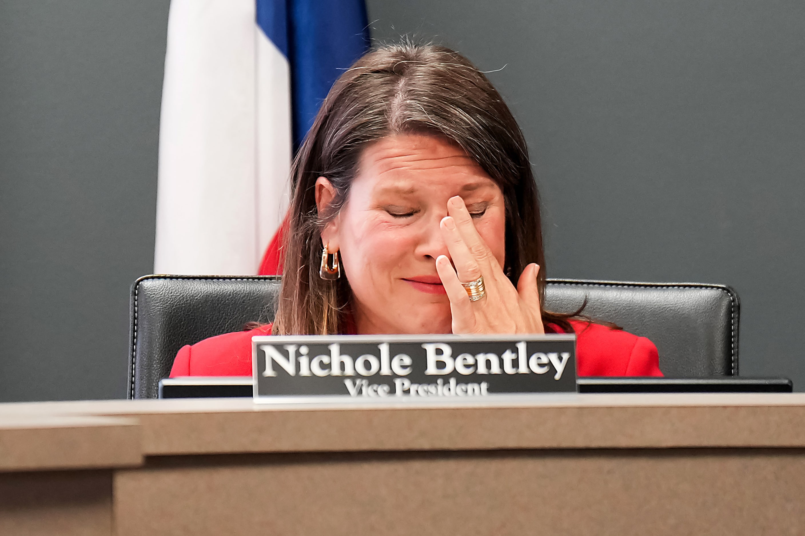 Coppell ISD school board vice president Nichole Bentley wipes away tears before voting to...