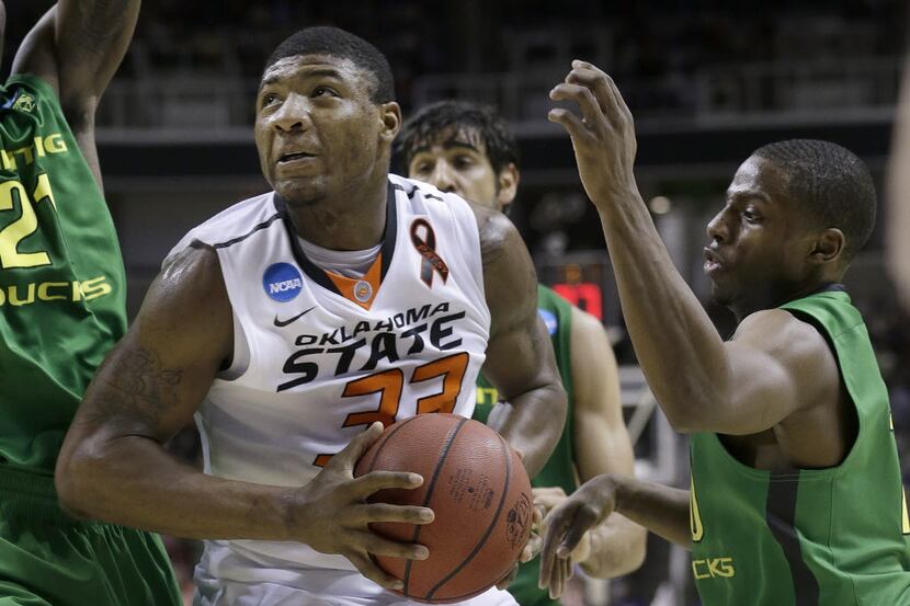 FILE - In this March 21, 2013 file photo, Oklahoma State guard Marcus Smart (33) shoots...