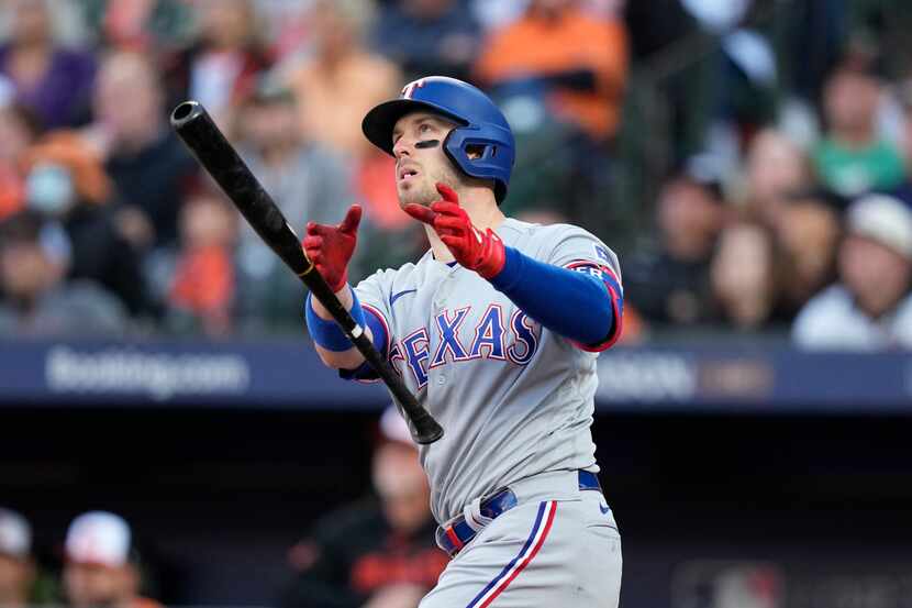 Texas Rangers' Mitch Garver drops his bat after hitting a grand slam during the third inning...
