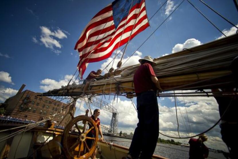 The crew of the Pride of Baltimore II prepares for docking in Duluth, Minn. Guests who pass...