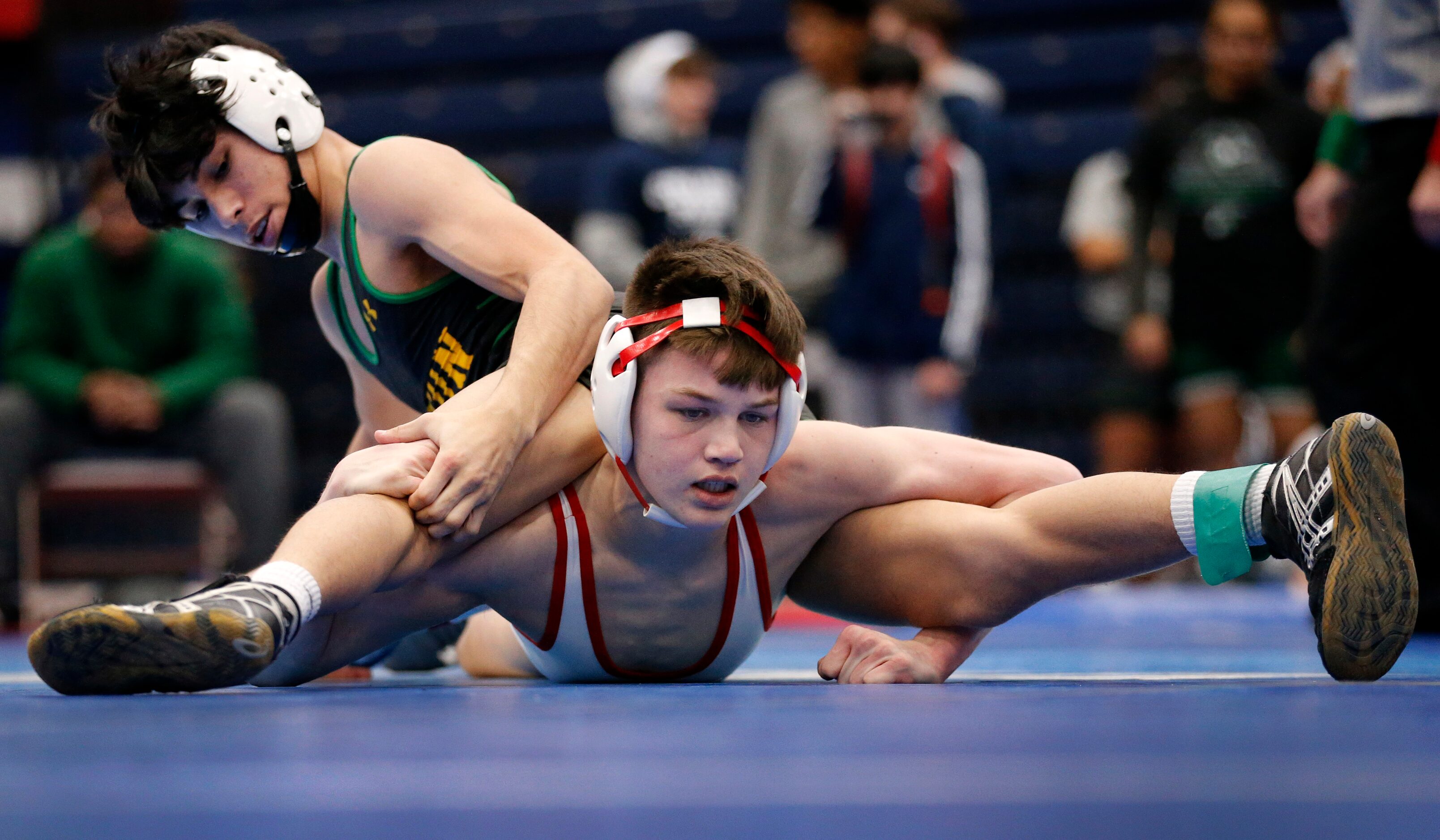 Allen High wrestler Caden Garcia (facing) battles Killeen Ellison High Eamonn Jimenez during...