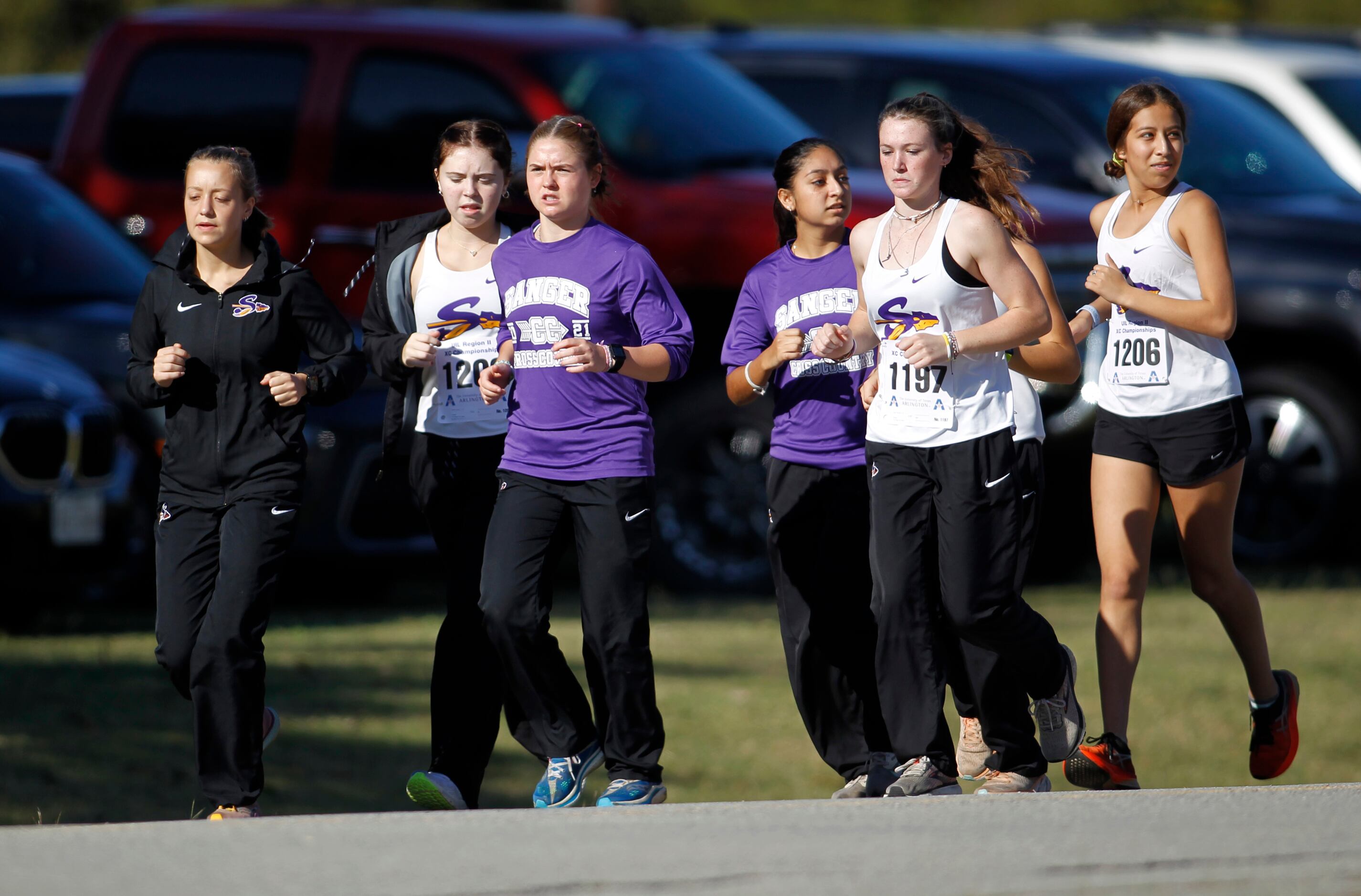 Members of the Sanger team warm-up prior to their girls race. The Class 6A Region ll cross...
