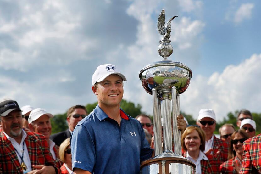 Jordan Spieth holds up the Marvin Leonard trophy after winning the Dean and Deluca...