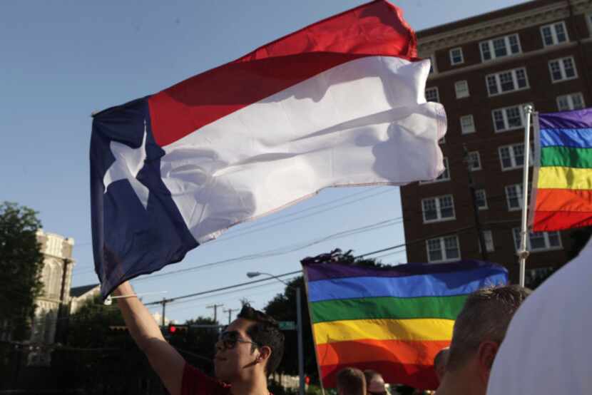 Frank Garza waved the Texas flag as members and allies of the Dallas lesbian, gay, bisexual...