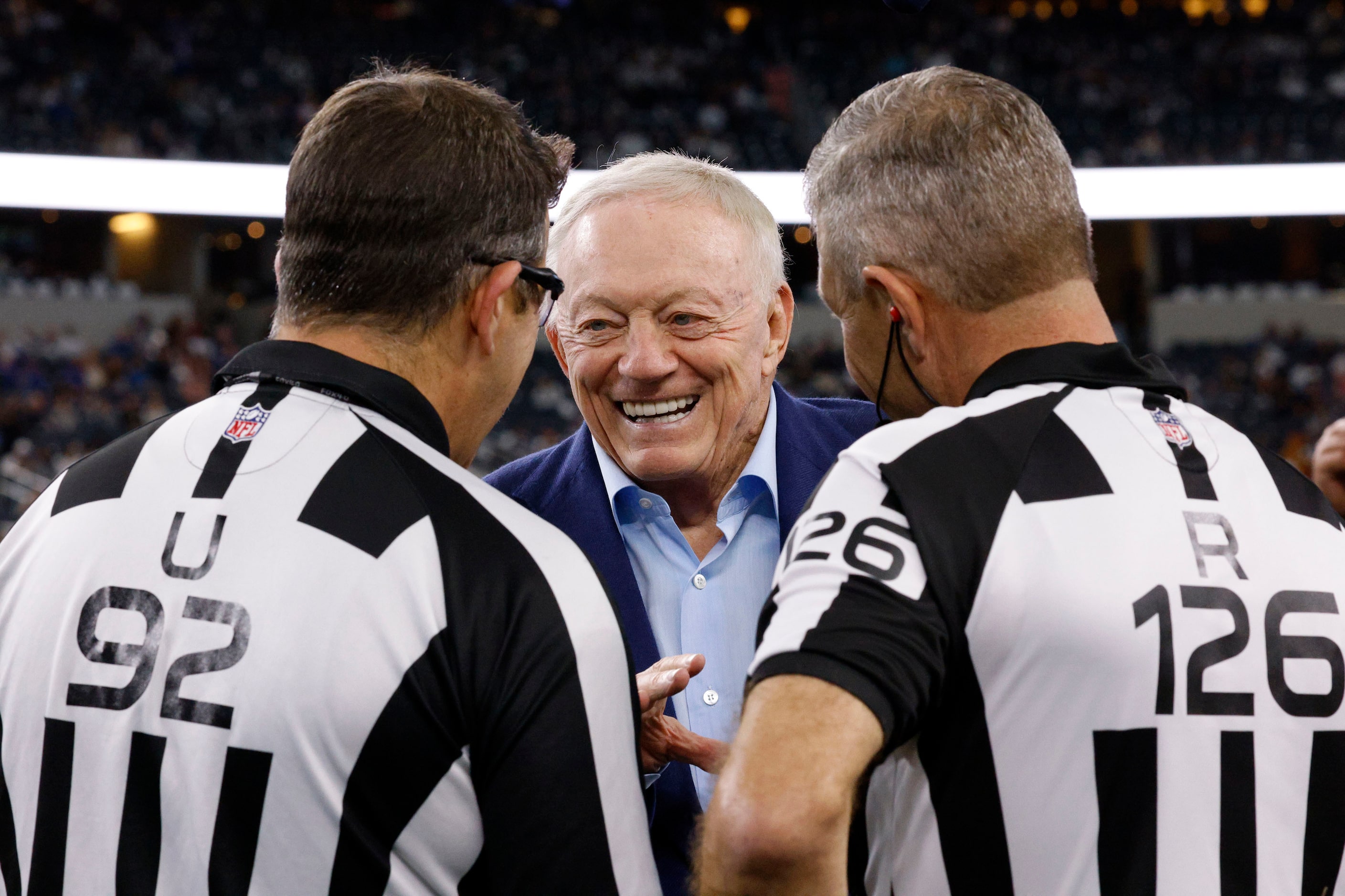 Dallas Cowboys owner Jerry Jones, center, talks with referees before an NFL football game...