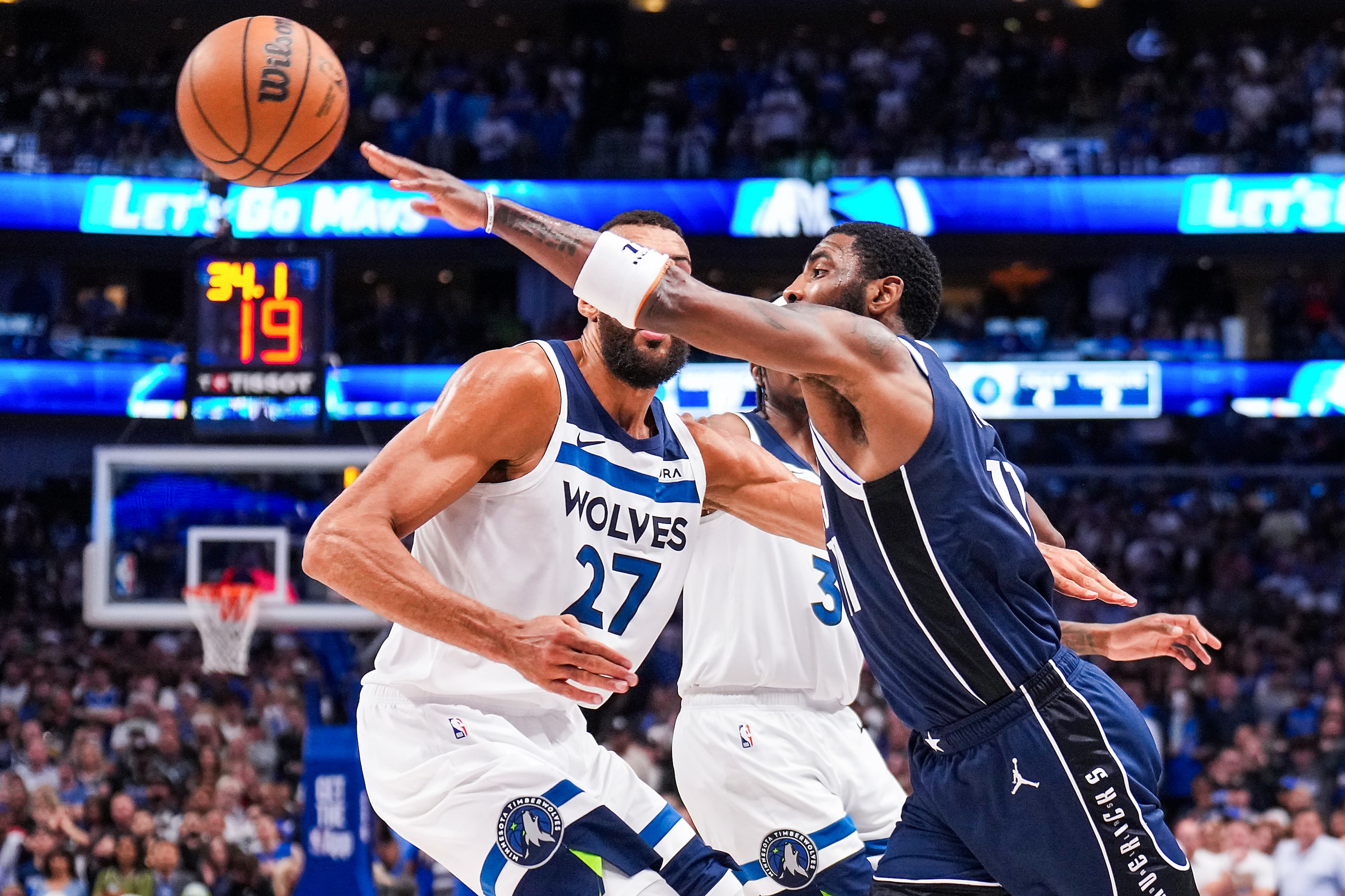 Dallas Mavericks guard Kyrie Irving (11) turns the ball over as he tries to pass around...