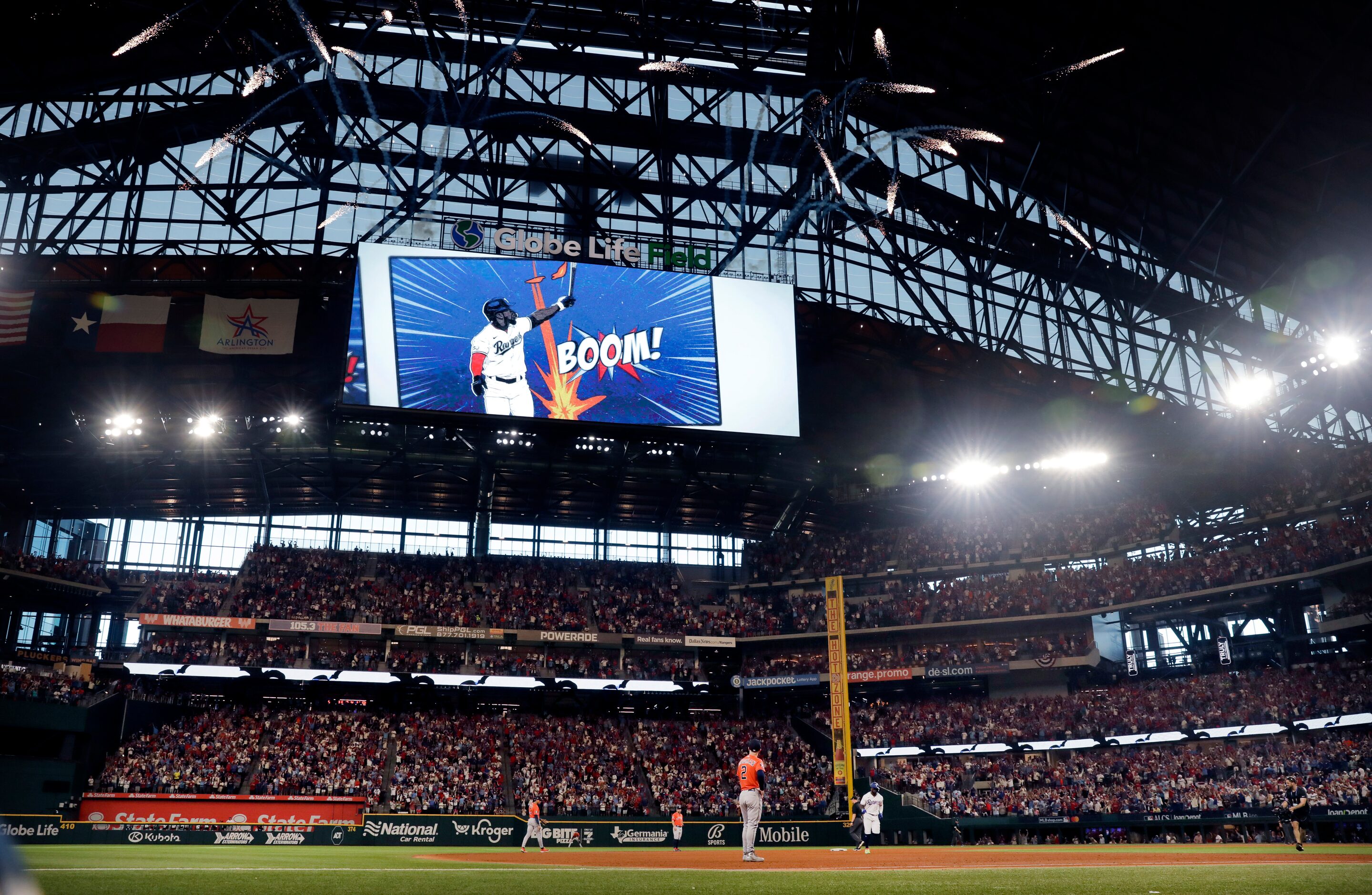 Fireworks explode as Texas Rangers batter Adolis Garcia rounds the bases after hitting a...