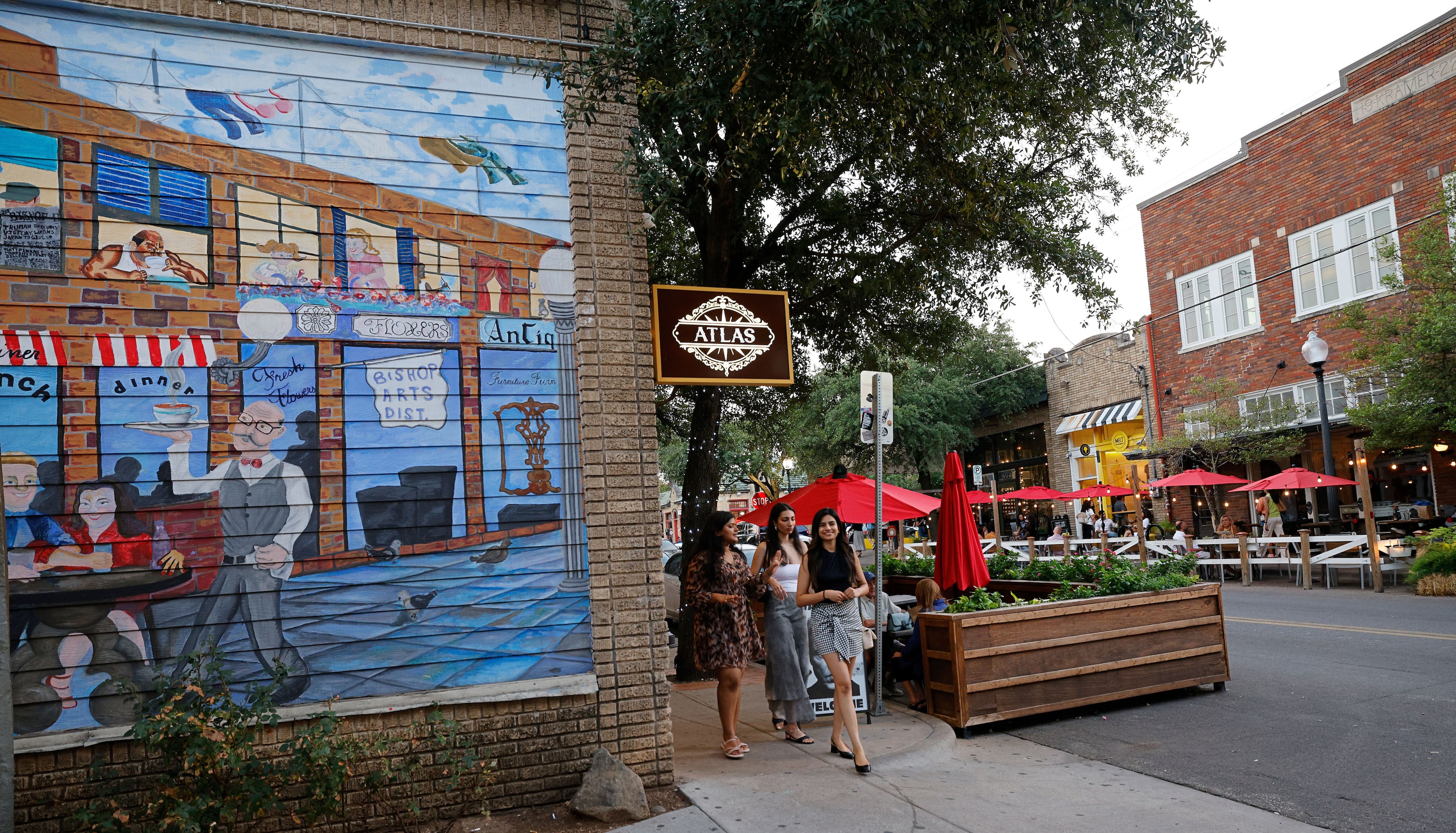 People walk along Bishop Avenue in the Bishop Arts District in Dallas, Saturday, Sept. 16,...