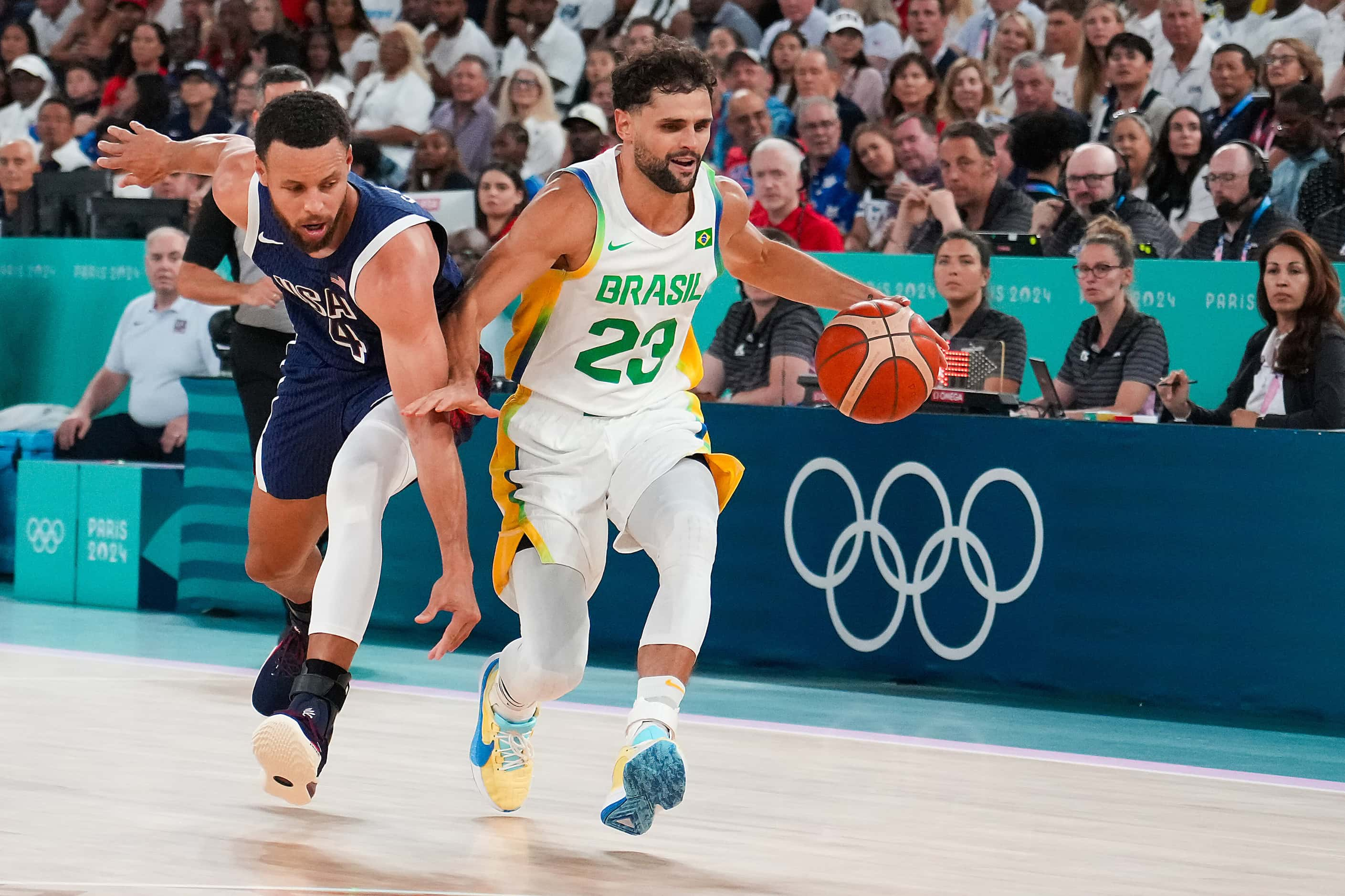 Stephen Curry (4) of the United States tries to steal the ball from Raul Neto (23) of Brazil...