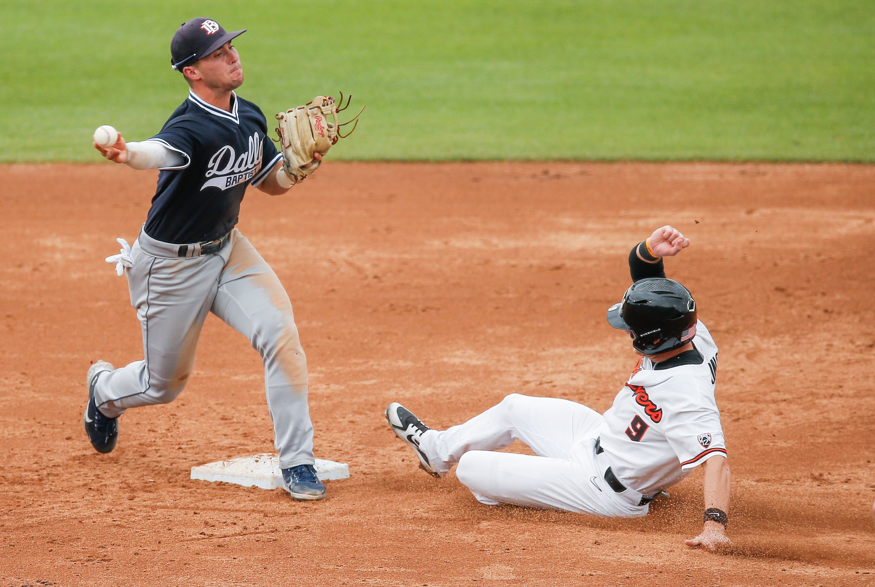 DBU infielder Jackson Glenn (3) throws to first for a double play after forcing out Oregon...