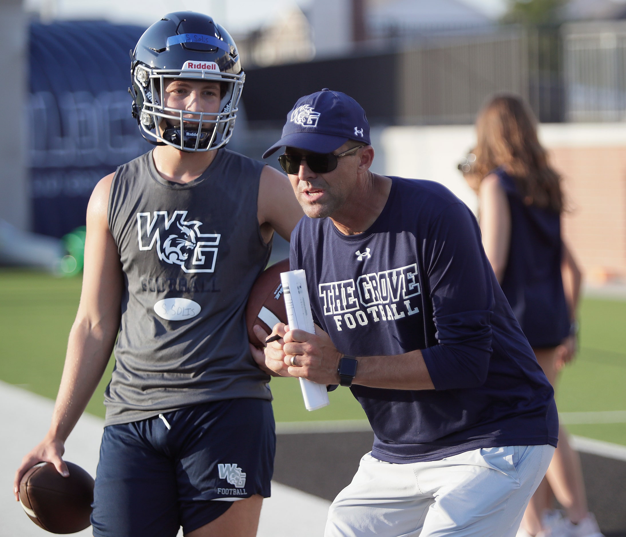 Head Football Caoch Tommy Allison (right) gives instruction to quarterback Sebastian Solis,...