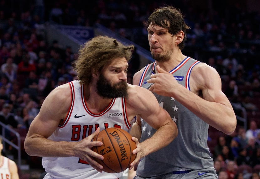 FILE - Chicago Bulls' Robin Lopez, left, makes his move against Philadelphia 76ers' Boban...