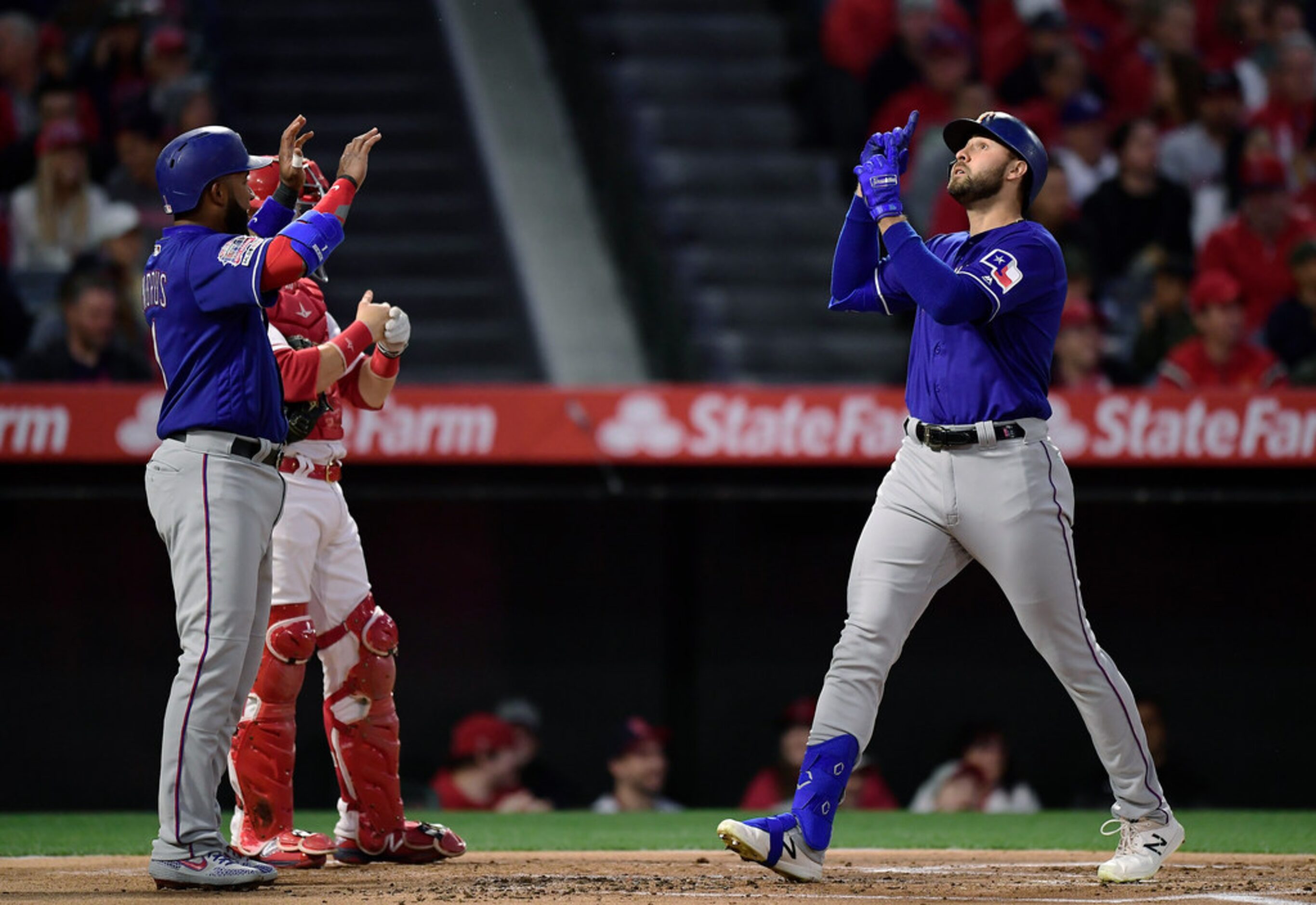 Texas Rangers' Joey Gallo, right, gestures as he scores after hitting a three-run home run...