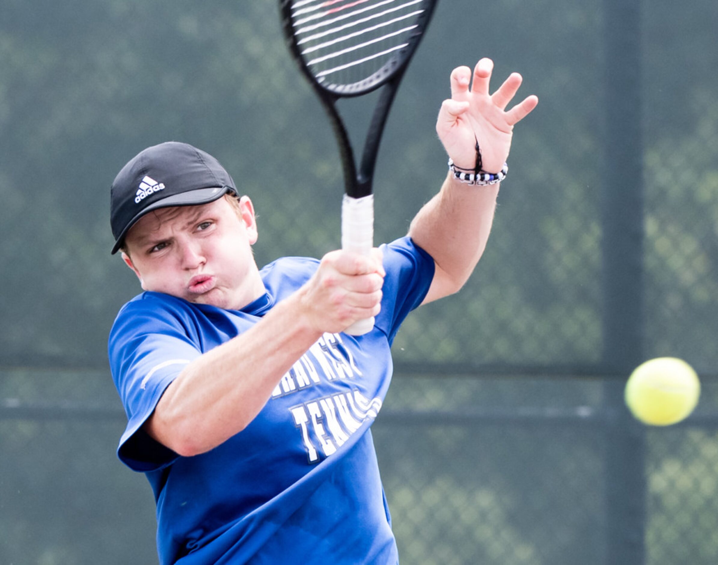 Plano West's Caden Moortgat returns the ball in a doubles match with teammate Emma Gener in...