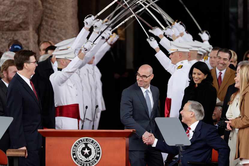 House Speaker Dennis Bonnen, center, congratulates Gov. Greg Abbott, right, and Texas Lt....