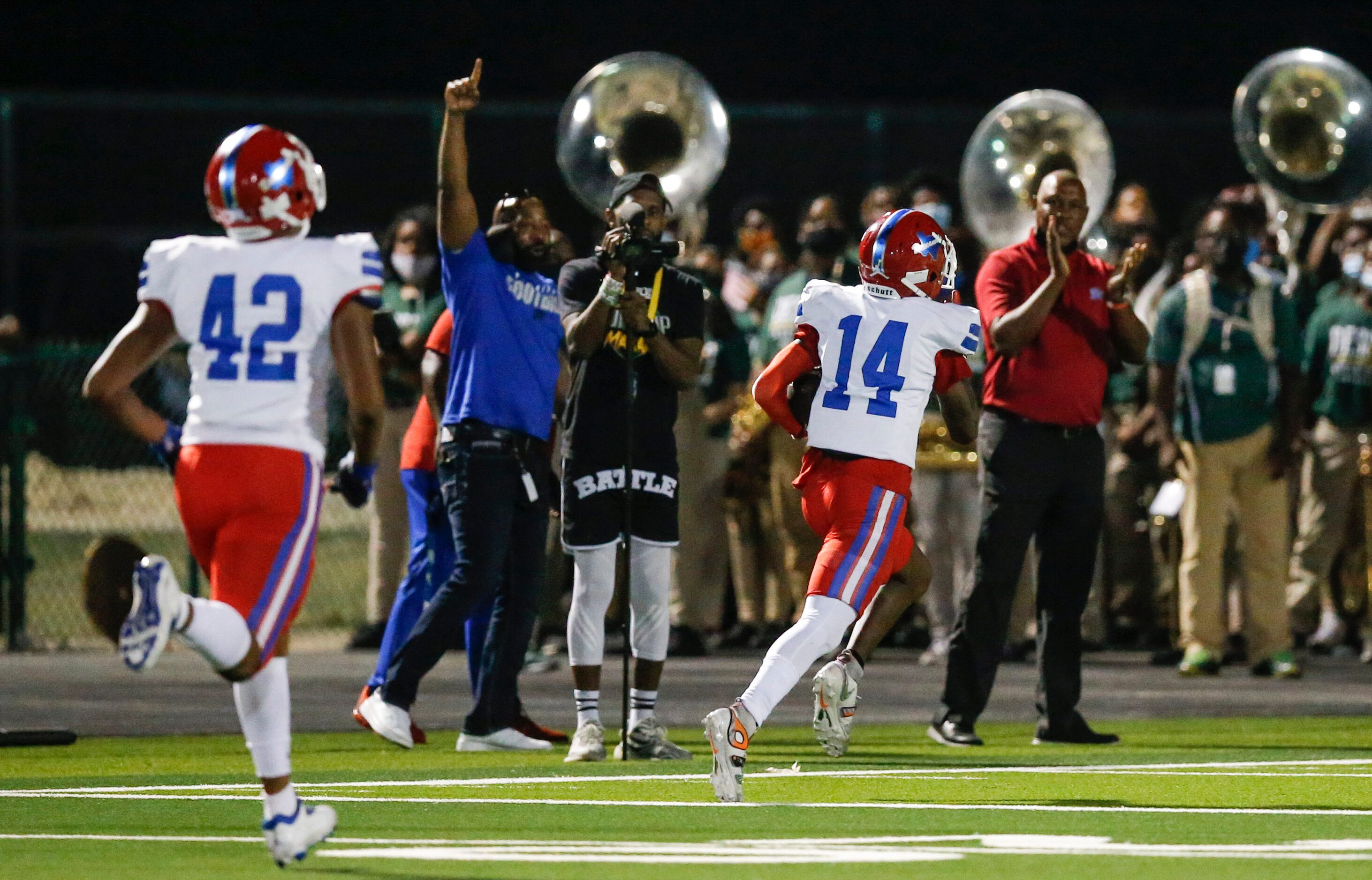 Duncanville senior punt returner Davion Bluitt (14) returns a DeSoto punt for a touchdown...