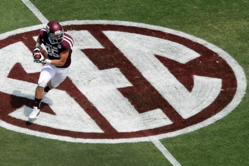 texas A&M wide receiver Ryan Swope turns upfield on the SEC logo after a first quarter pass...