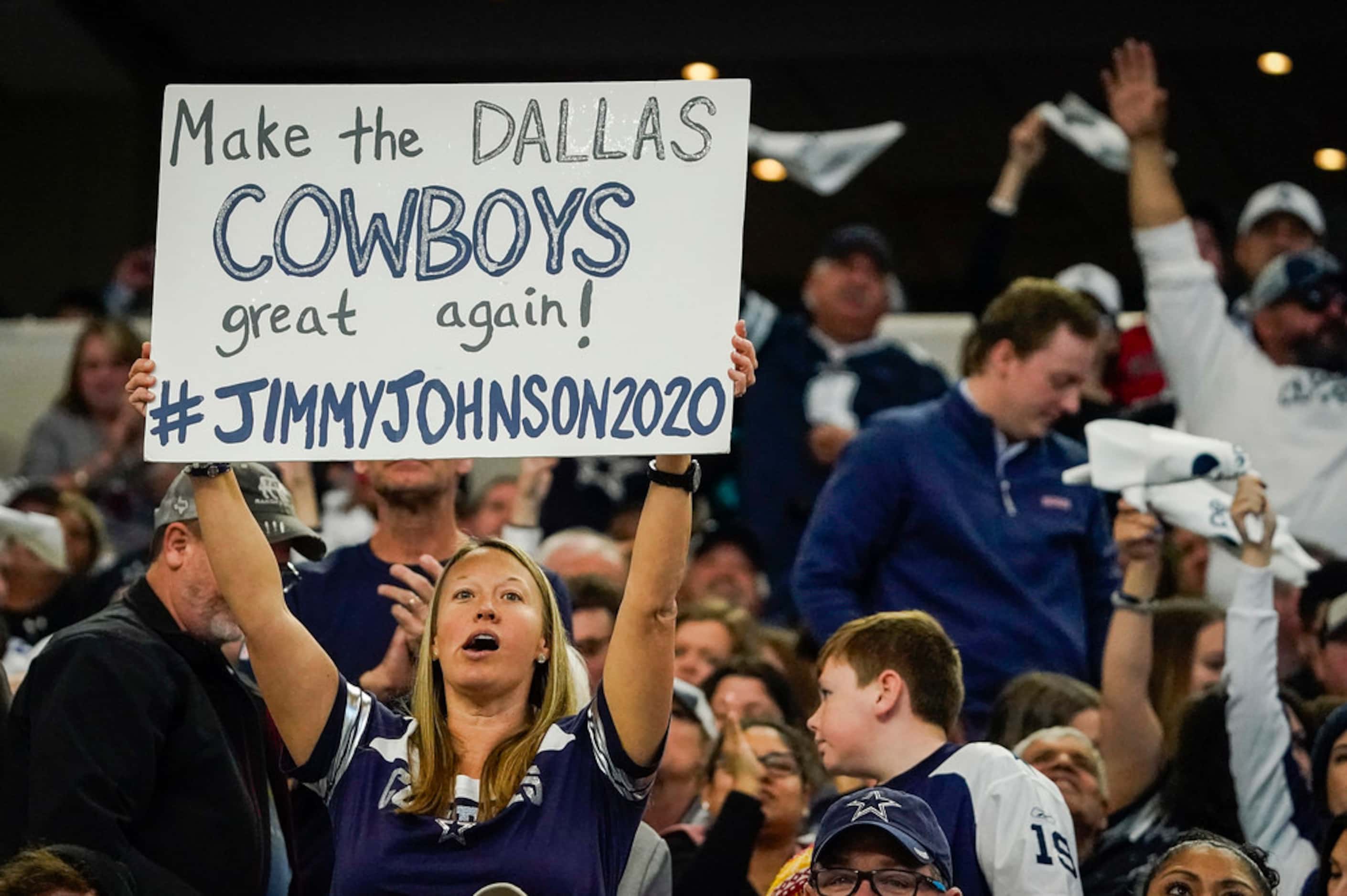 A Dallas Cowboys fan holds a sign calling for a new coach during the first half of an NFL...