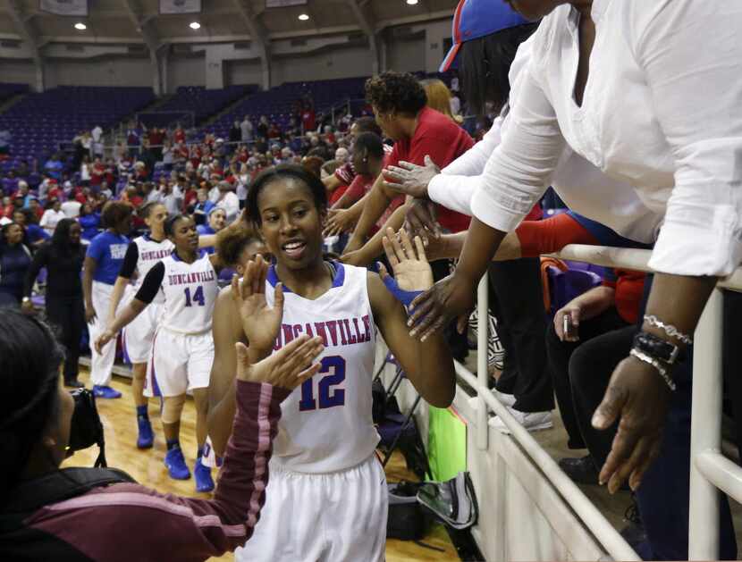 Duncanville's Ariel Atkins (12) celebrates their victory over  LD Bell, with fans, after...