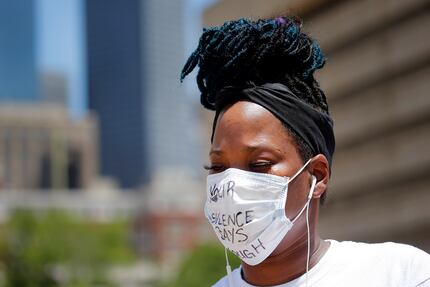 Adrienne Peoples of Plano wore a protective mask with the phrase "Your Silence Says Enough."