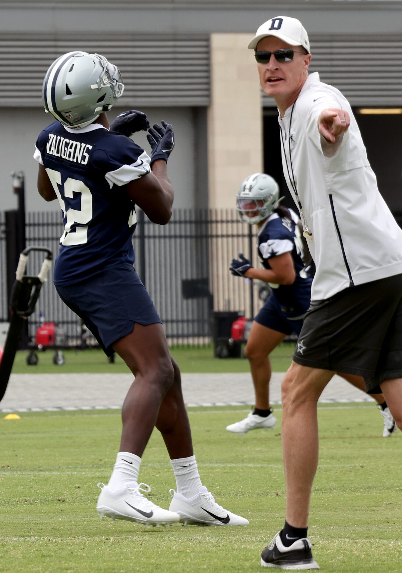 Dallas Cowboys special teams coach John Fassel directs players through a kickoff/ punt...