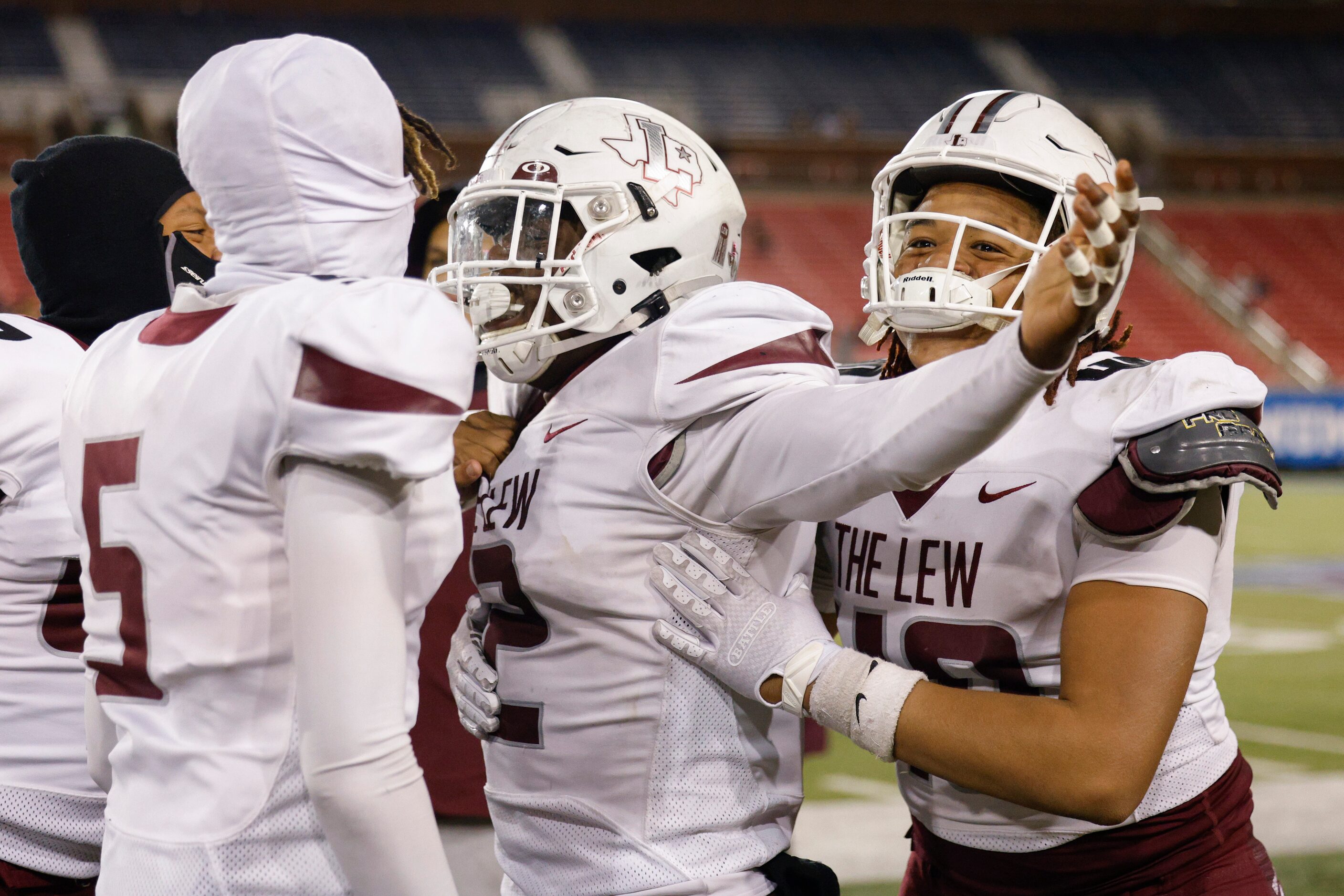 Lewisville linebacker Mark Cooper (center) celebrates his interception with teammates during...