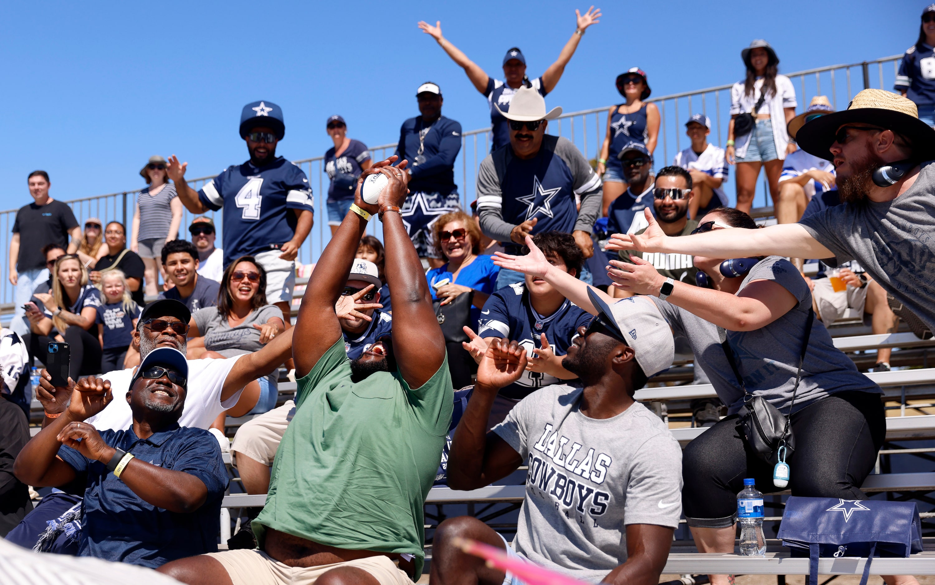 Femi Abebefe of Las Vegas (center) reaches and catches a souvenir football thrown by Rowdy,...