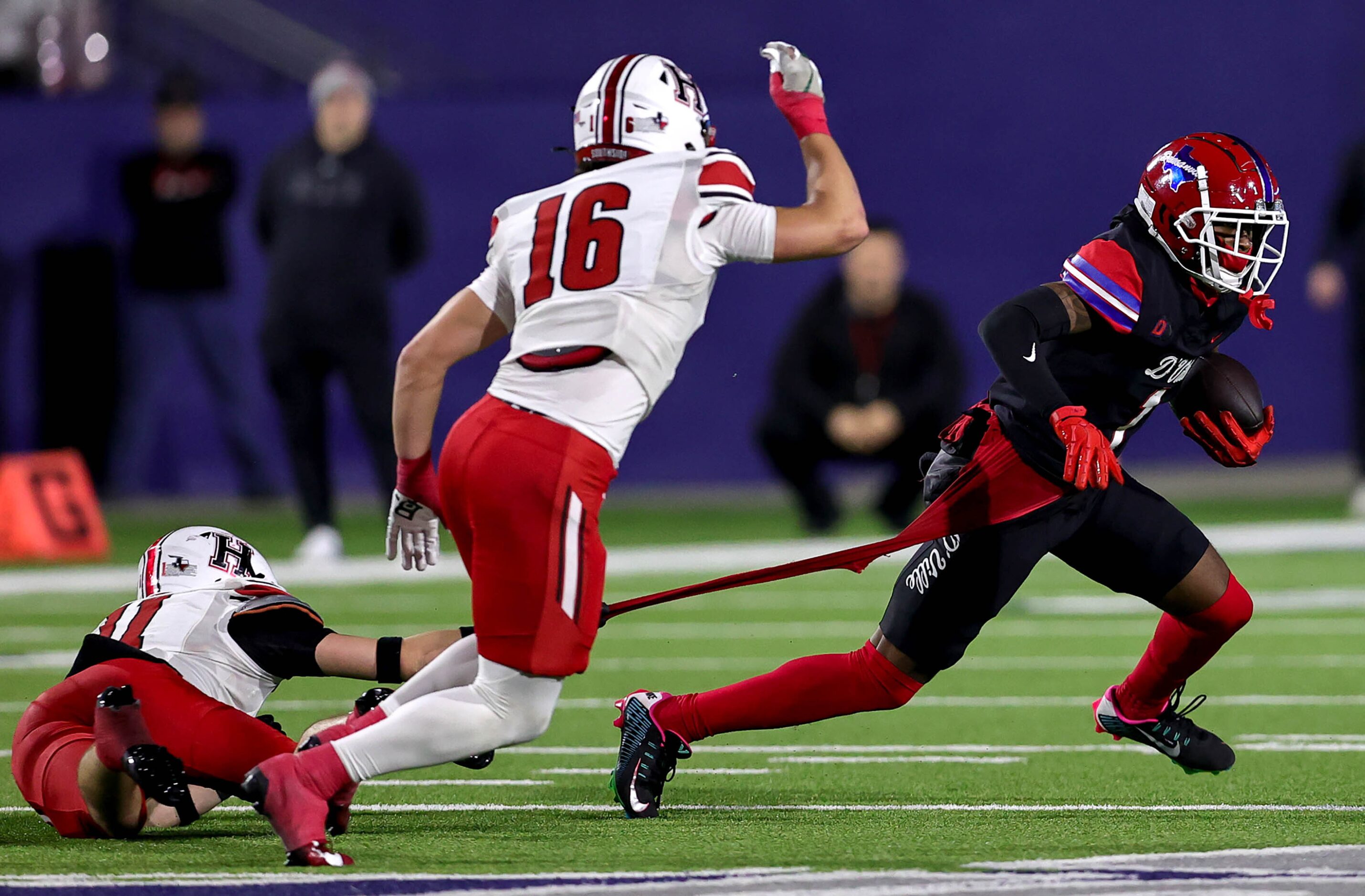 Duncanville wide receiver Dakorien Moore (1) gets his jersey pulled by Rockwall Heath...