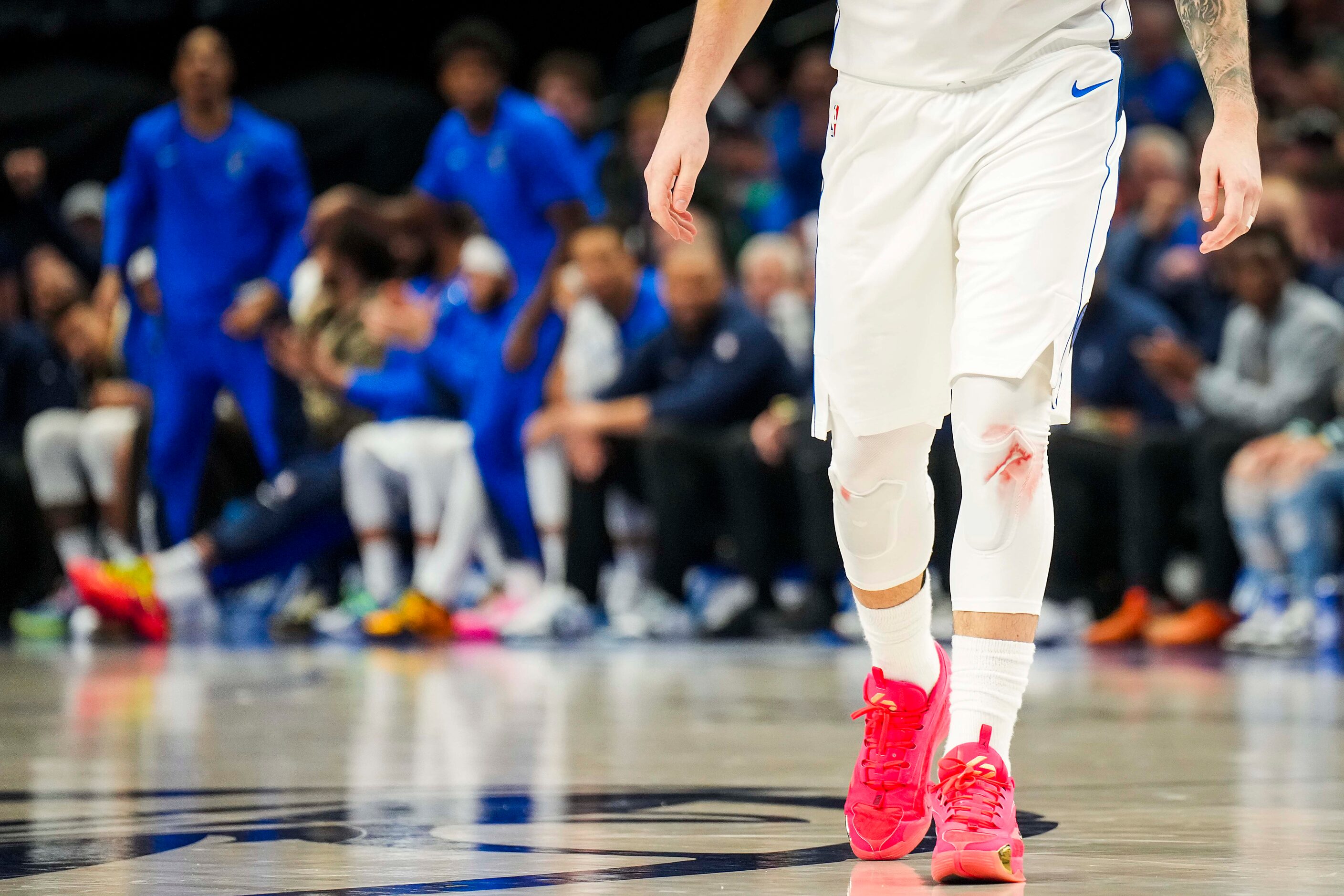 The knees of Dallas Mavericks guard Luka Doncic are discolored during the second half of an...