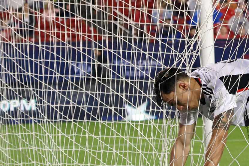 FC Dallas attacker Petar Musa (9) reacts as he grabs the webbing inside an empty goal after...