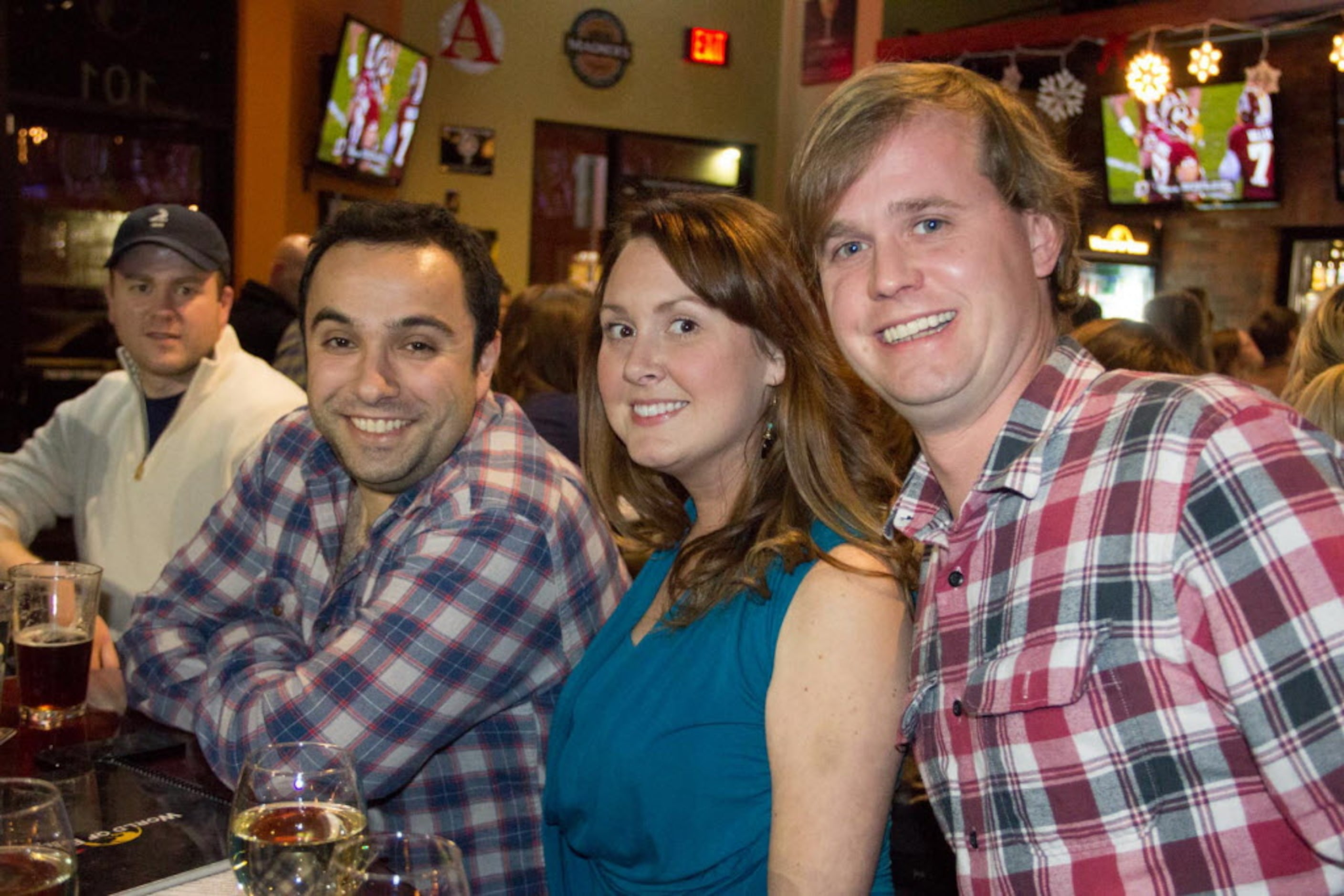 Oktay Rifki, Erin Clack and Kyle Richards enjoy beers with friends at World of Beer on Dec...