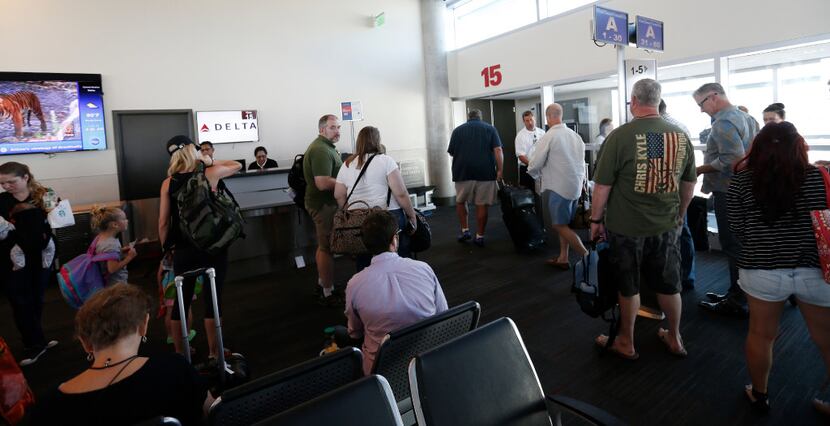 Passengers get to board at Delta flight at Dallas Love Field Airport in Dallas, Wednesday,...