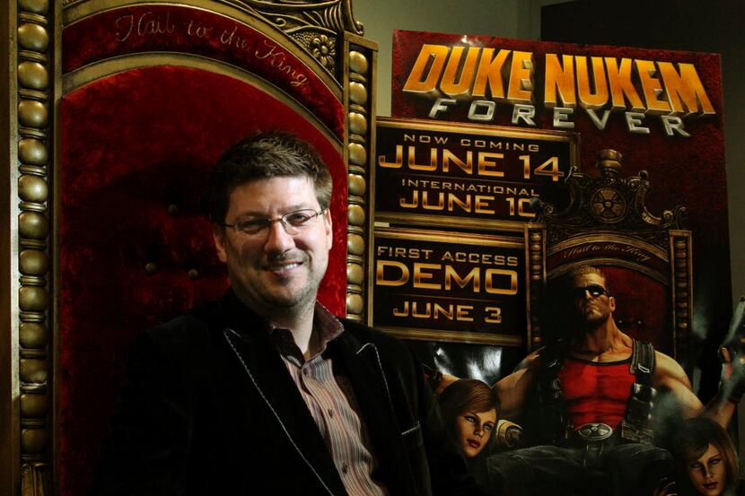 Randy Pitchford, CEO & President of Gearbox Software poses with some of the company's Duke...