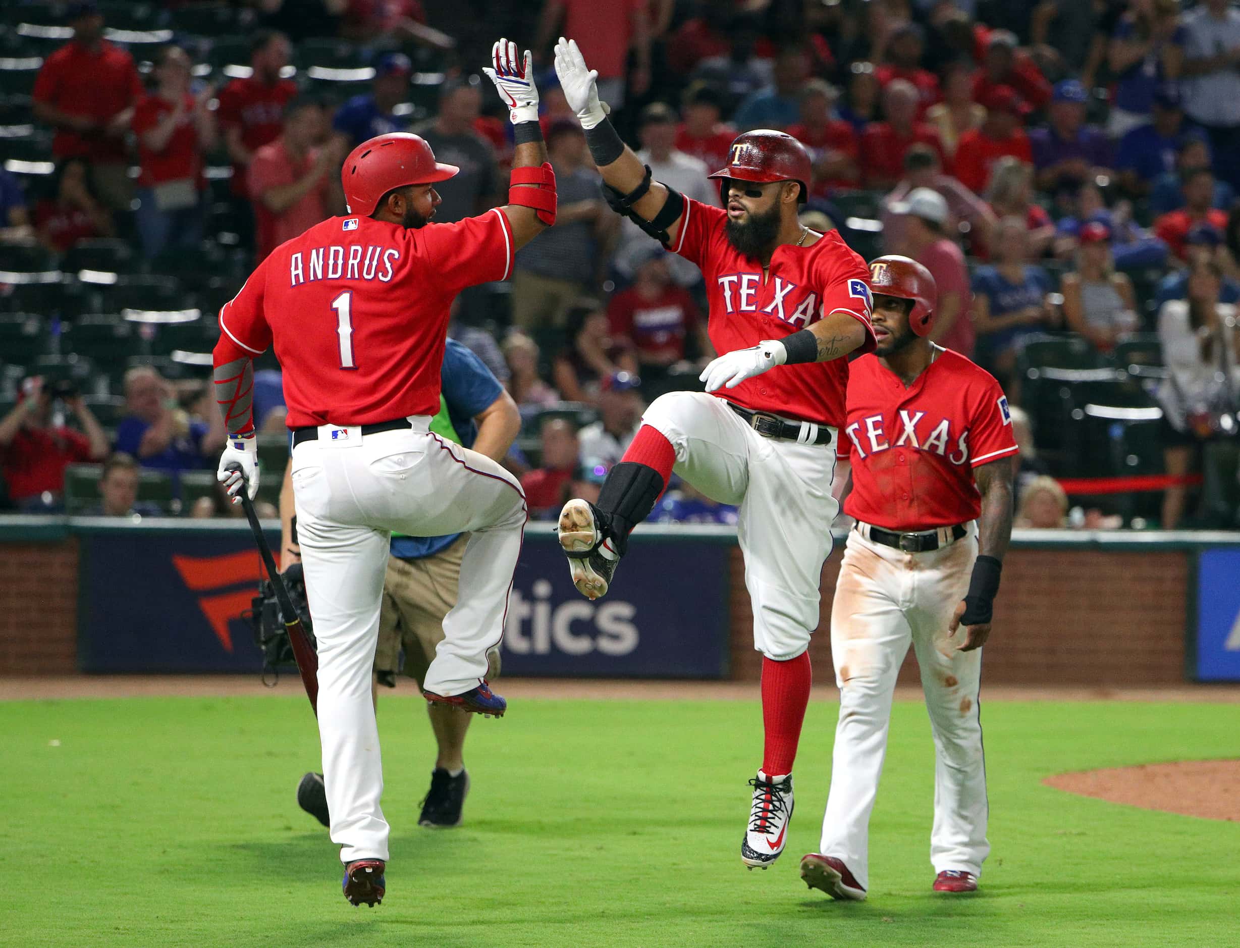 Elvis Andrus and Rougned Odor celebrate a home run in the Rangers' 2018 home reds. The...