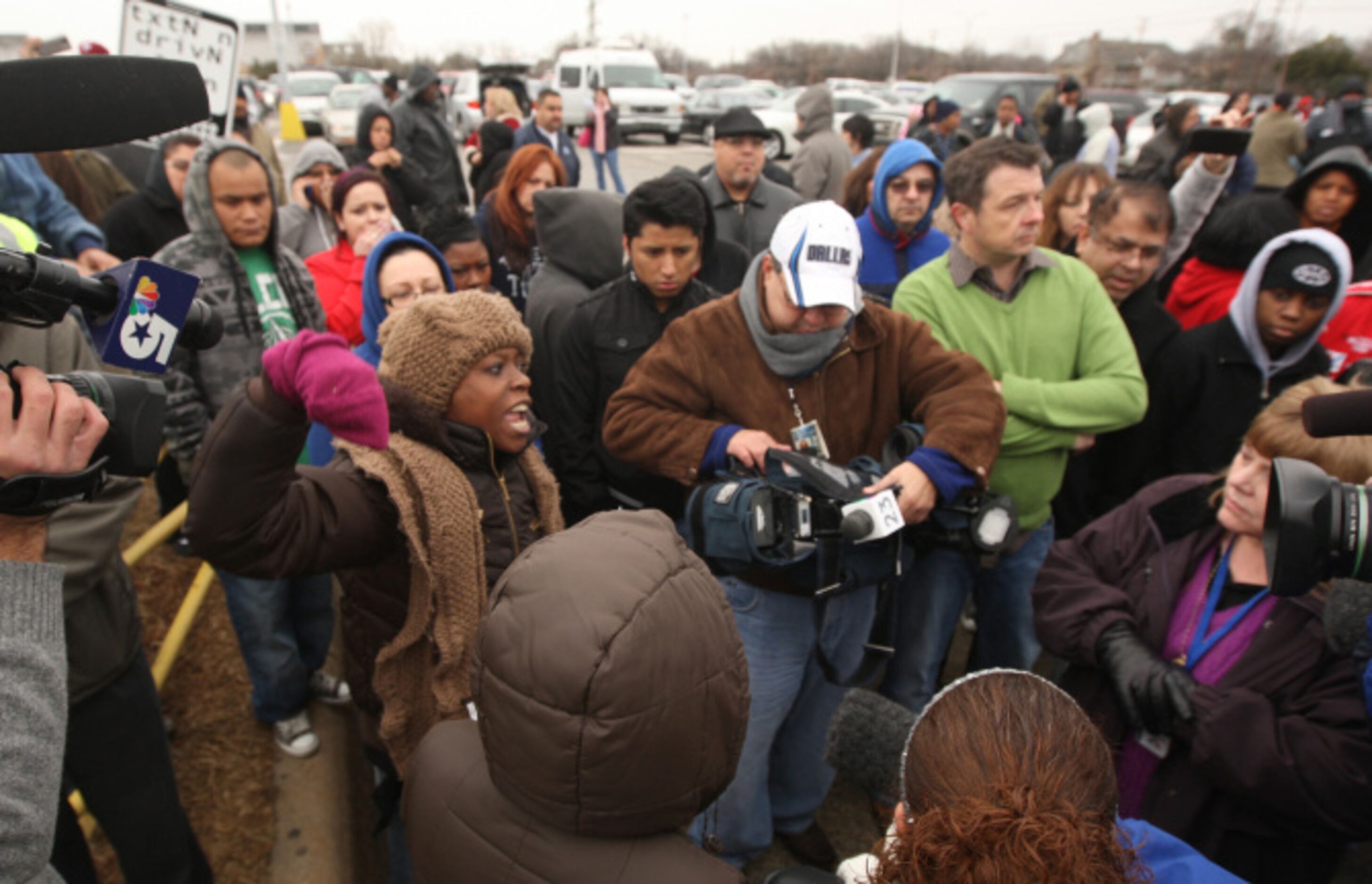 Parent Latonya Davis, left, shows her frustration on not hearing any news during a lockdown...