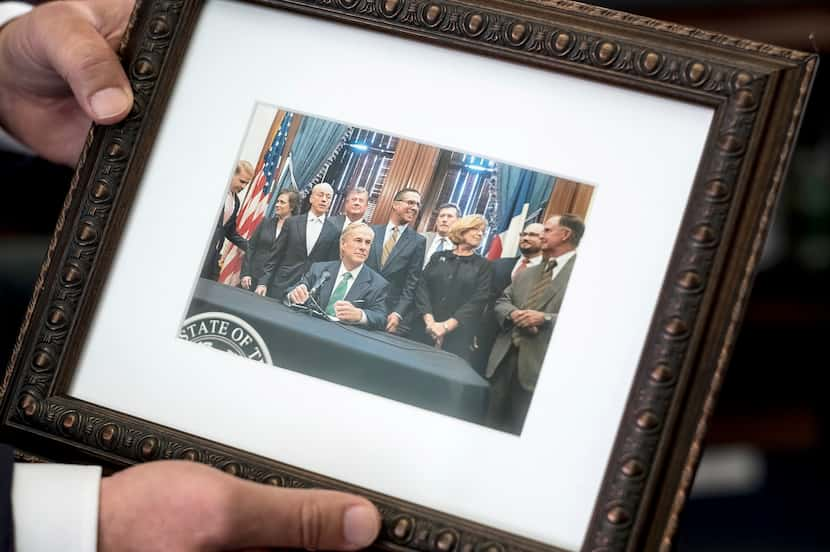 As he packed a box of personal mementos on his last day as Gov. Greg Abbott's chief of...