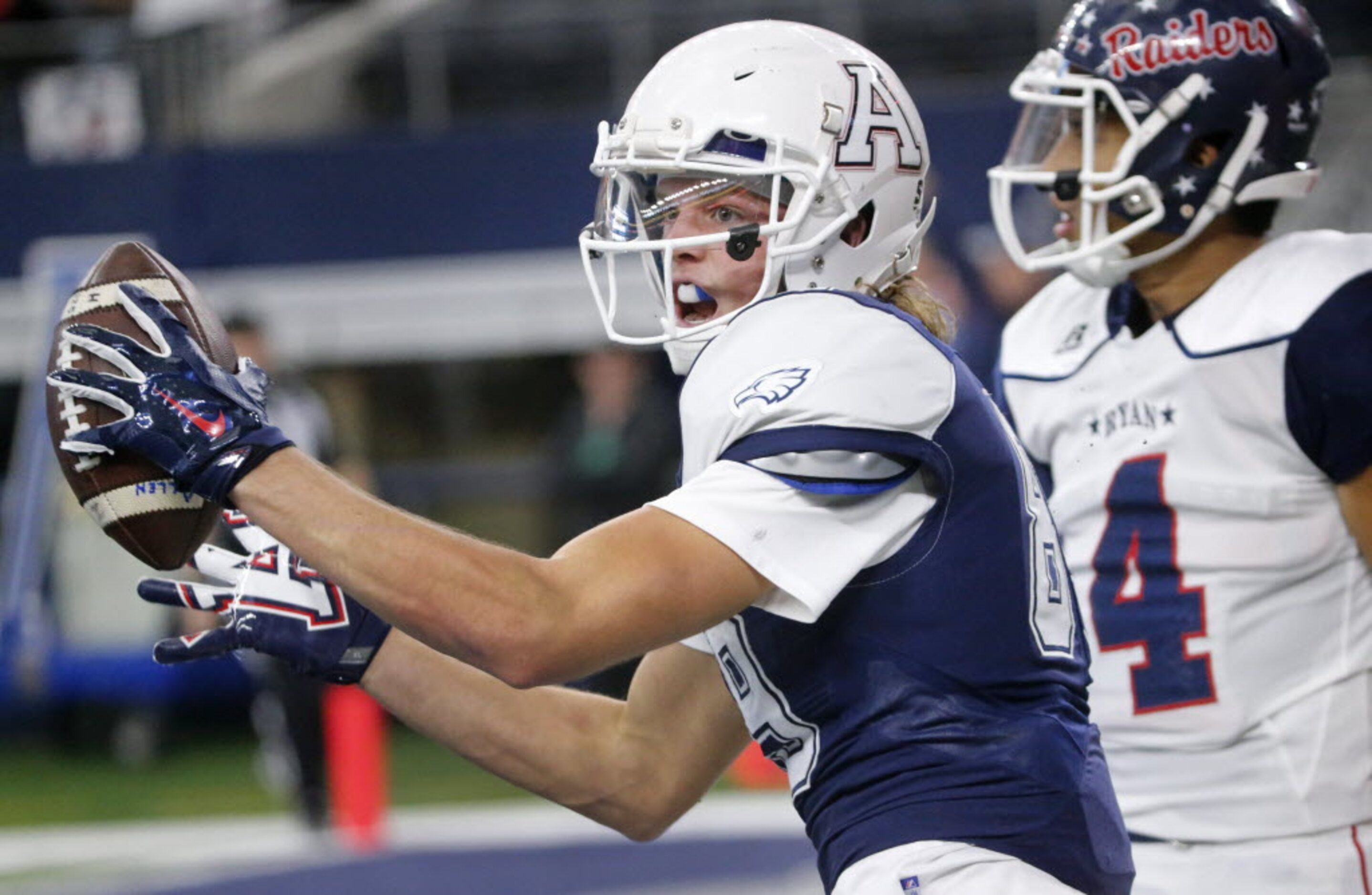 Allen receiver Camden Harrison, left, celebrates a touchdown reception in the second quarter...