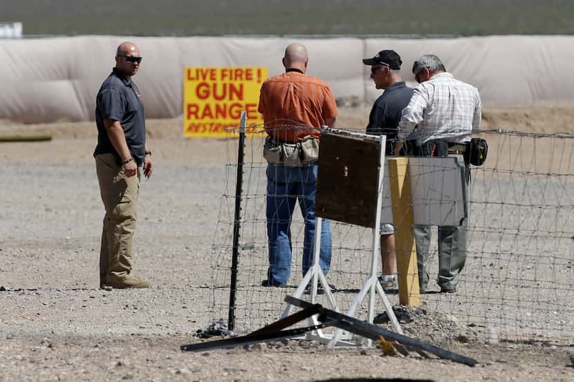 People are seen at the Last Stop outdoor shooting range Wednesday, Aug. 27, 2014, in White...