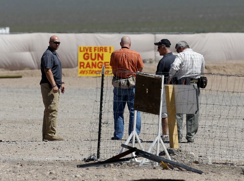 People are seen at the Last Stop outdoor shooting range Wednesday, Aug. 27, 2014, in White...