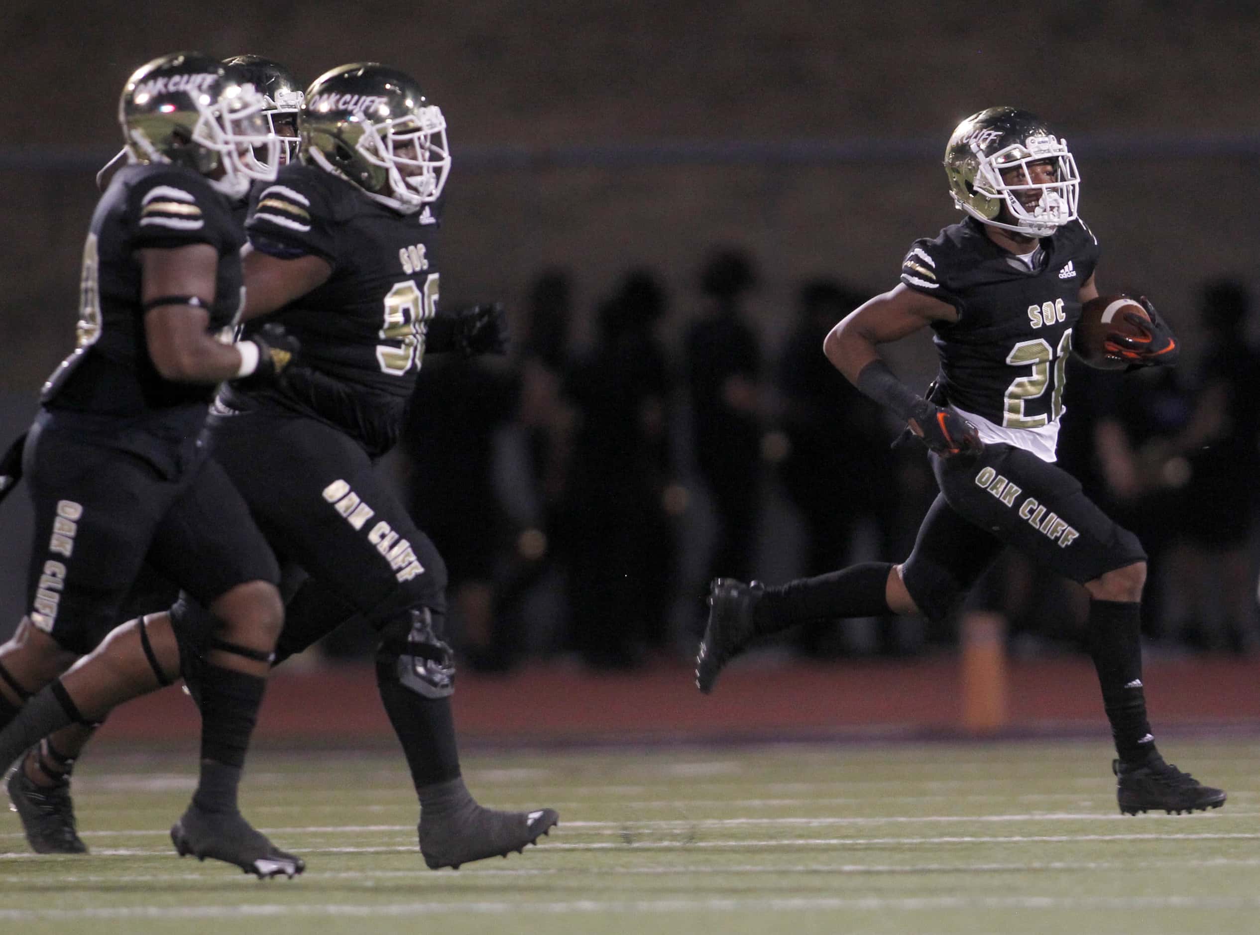 South Oak Cliff defensive back David Spruiells (21), right, sprints to the team bench after...