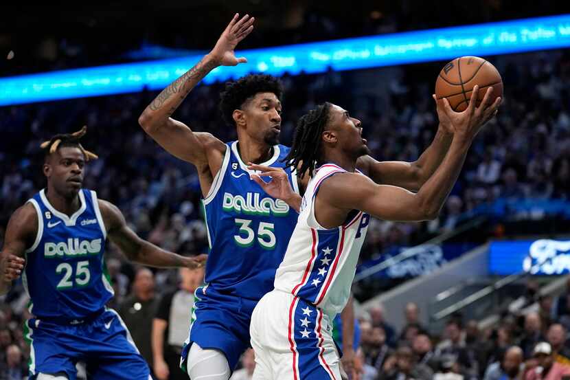Philadelphia 76ers guard Tyrese Maxey (0) drives to the basket for a shot past Dallas...