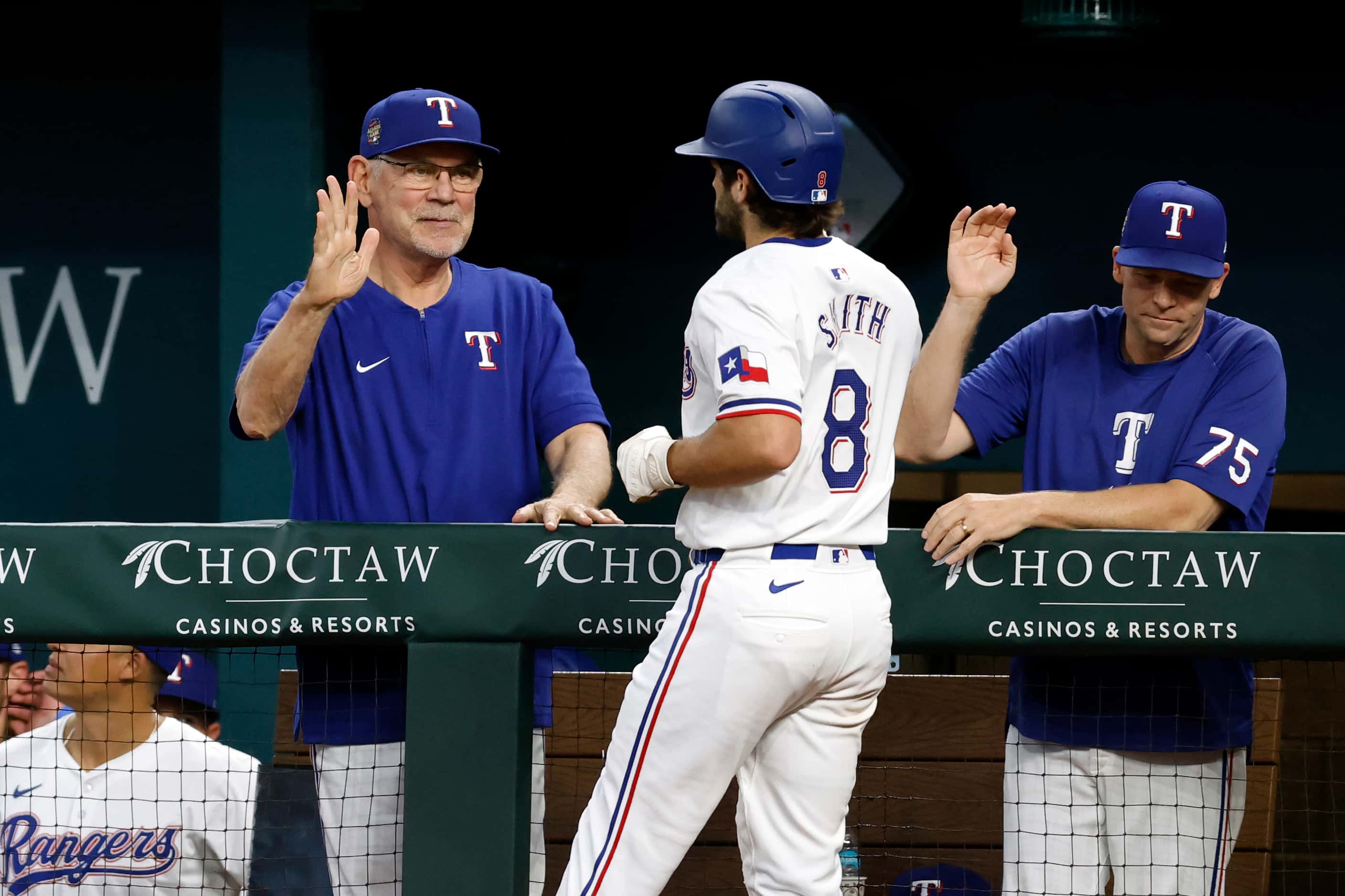 Texas Rangers third baseman Josh Smith (8) celebrates his home run with manager Bruce Bochy...